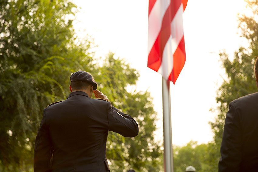 U.S. Marine salutes the flag after they lowered it to half mast at the Pelco 9/11 memorial service.