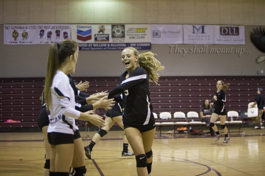 Freshmen Kamryn Schultz celebrates with her teammates at the beginning of the game.