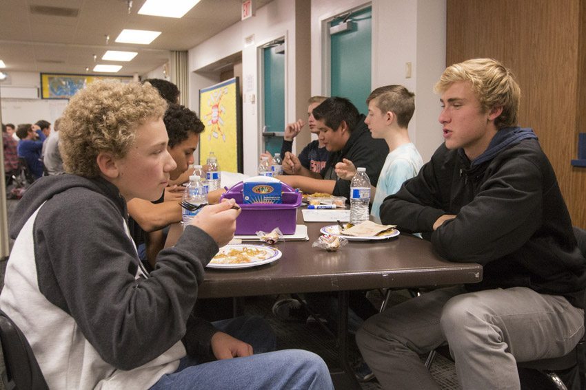 Junior high and high school members of the Brother to Brother join together in Terry Richards room for the end of the year gathering lunch, Dec. 8.