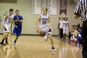 Daniel Walker, '17 dribbles the ball down the court during a home game against 