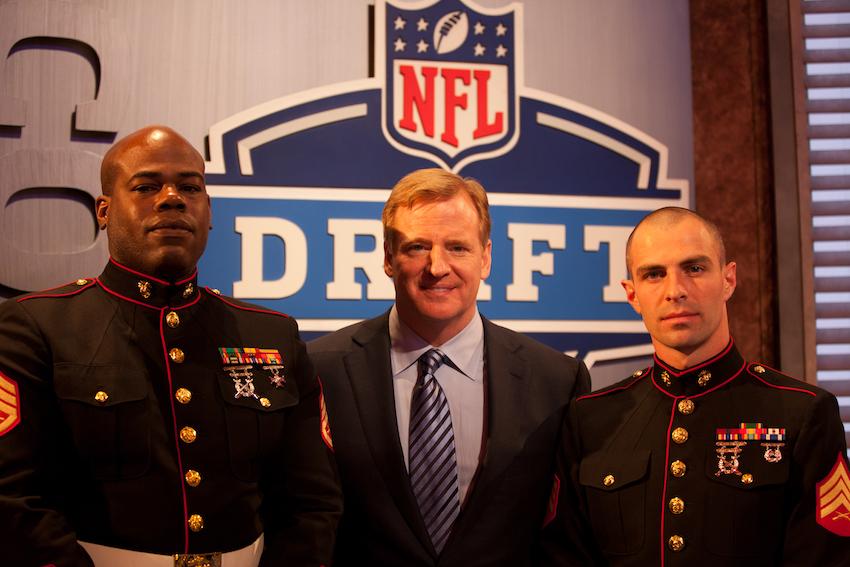 Sgt. Luke Boyd (L) and Staff Sgt. Marlon Green pose for a picture with NFL commissioner Roger Goodell at the National Football League Draft on April 26 at Radio City Music Hall.  Boyd, a 25-year-old native of Baton Rouge, and Green, a 32-year-old native of Chicago, were recognized by the NFL at the draft. Boyd who works at Marine Air Command and Control Squadron Experimental Operational Development Team, Marine Corps Air Ground Combat Center Camp Pendleton, Calif., and Green from Combat Logistics Company 21 at Marine Corps Air Station Cherry Point, N.C., are the most valuable player picks from their respective base full contact football teams. (Official Marine Corps photo by Gunnery Sgt. Matthew Butler / RELEASED)