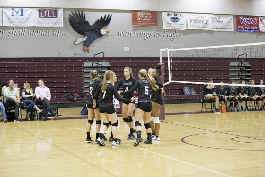 FC volleyball team celebrates after scoring point. 