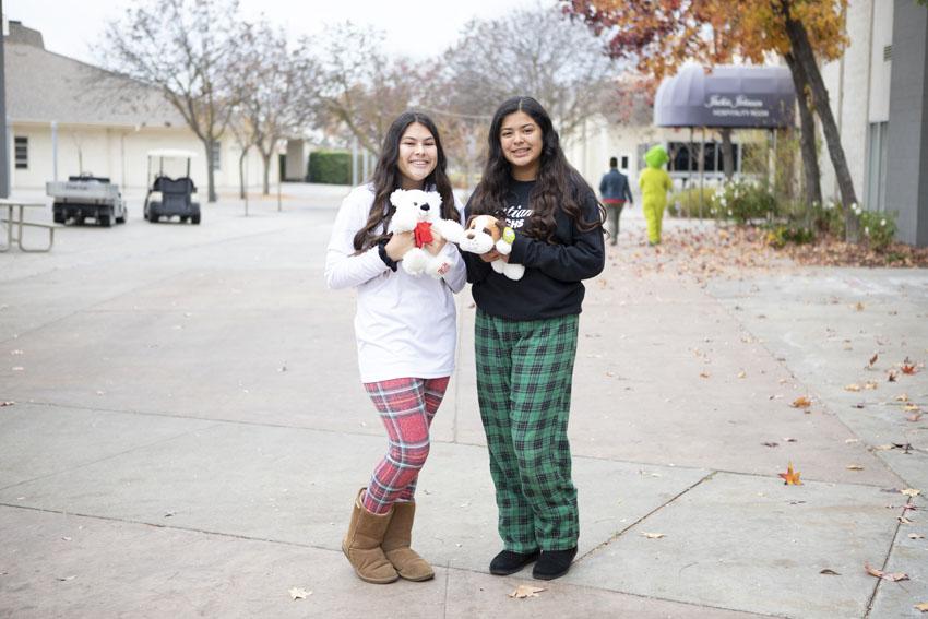 Sophomores Faith Monroy(left) and Celeste Castaneda bring stuffed animals to donate to Valley Children's Hospital, Dec. 14. 