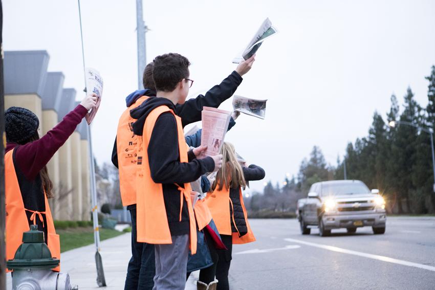 Feather staff and leadership students sell Kids Day newspapers on street corners, March 5. 