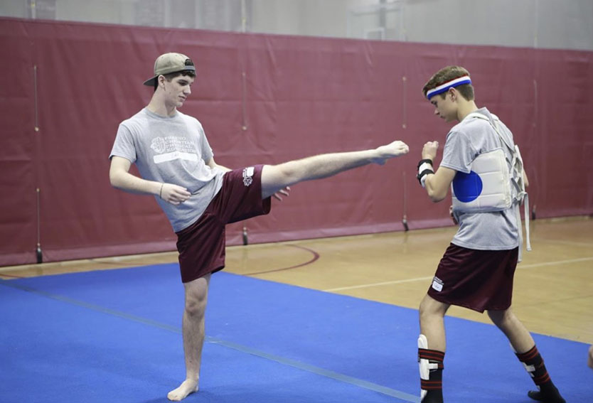 Cohl Obwald, 21,(left) instructs  Edward Fikse, 22, (right) during third period physical education class, Sept. 25