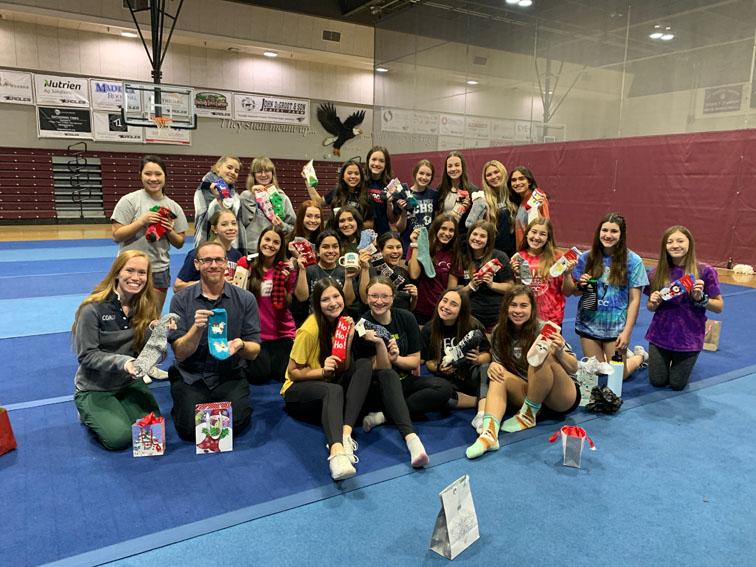 Varsity cheer team exchanges socks during an early morning Christmas party, Dec. 