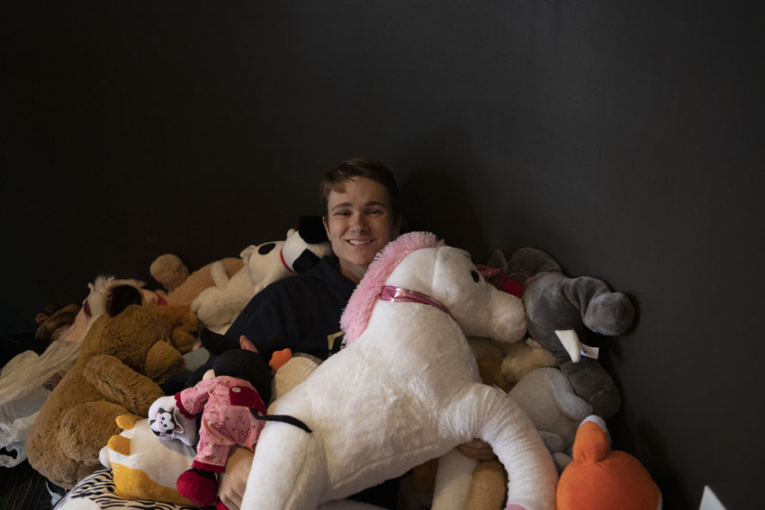 Sophomore Edward Fiske gathers stuffed animals the students have donated for children in the hospital, Dec. 13.