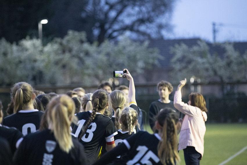 Captain, Avery Jones, 20, takes a selfie with the team before the game, continuing the tradition, Feb. 21.
