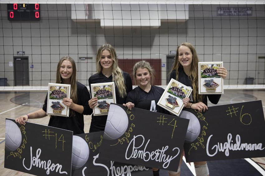 Girls volleyball seniors, (left right) Natalie Johnson, Annalouise Sheppard, Emily Penberthy and Jacklyn Guglielmana, are congratulated alongside their family during Senior Night, Oct. 14. 