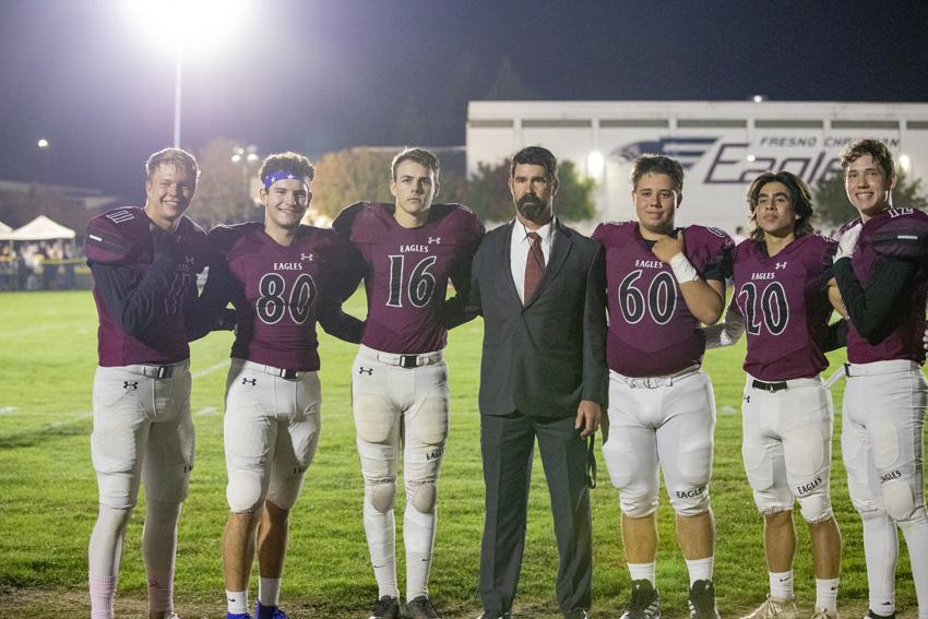 Football seniors are honored before kickoff by packed stands and coach Mick Fuller, Oct. 28.