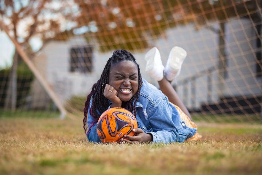 Kemya Hopkins challenged on the soccer field