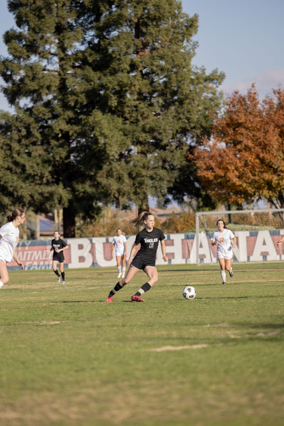 Senior Grace LaCroix pushes the ball toward the goal as she leads her team along with the other seniors.