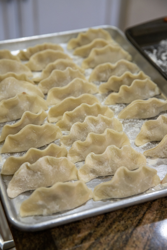 Every family has their own style of folding dumplings. These showcase a wavey taco shape for potstickers.
