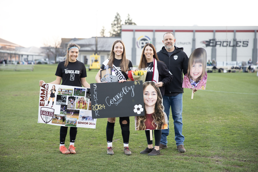 Senior and captian, Emma Connolly, poses with her family and younger sister, Meghan Connelly who is also on the team as well, Feb. 13
