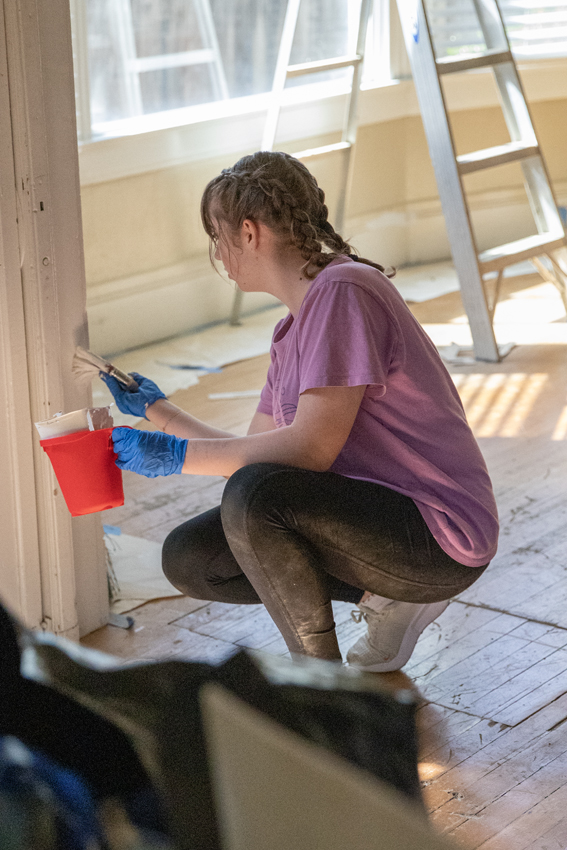 Freshman Emma Wilson spends her Friday painting and touching up areas in the Evangel Home.
