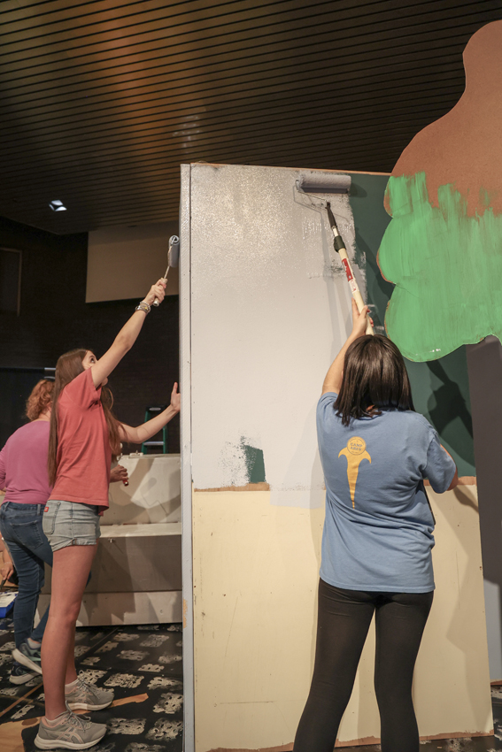 Drama students help paint set backdrops for the upcoming production. 
