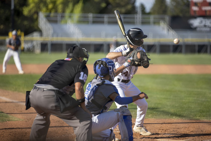 Umpire+and+Caruthers+catcher+prepare+themselves+for+a+fast+ball+as+Three+year+varsity+baseball+player+Lucas+Adanalian%2C25+is+up+to+bat%2C+April+12.