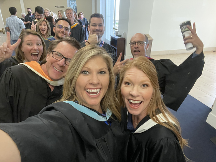 Graduation day staff selfie tradition. 