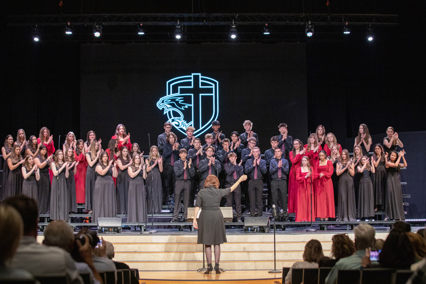 Choir director Susan Ainley leads the Concert choir in rhythmic clapping in the song Ritmo, May 6.