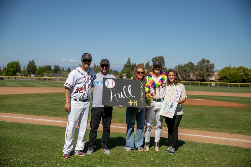 Jake Hull poses with his family and coach as they celebrate Senior Night together, May 7.