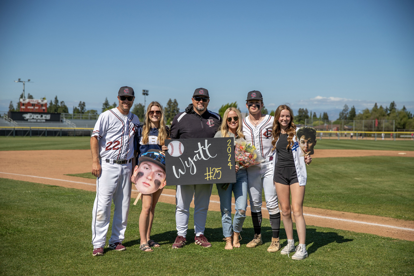 Jake Wyatt poses with his family and coach as they celebrate Senior Night together, May 7.