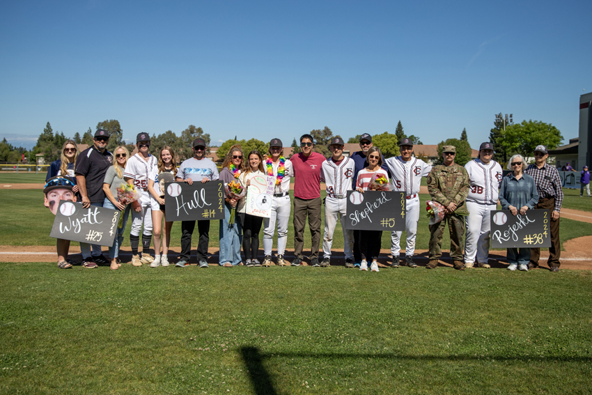 The four senior families gather together for a group photo on Senior Night, May 7.