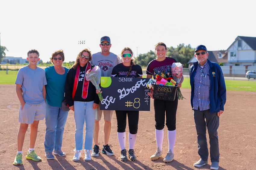 Senior, Faith DeGroot poses with her family and her sister, Jordyn DeGroot, who is on the team as well, May 7. 