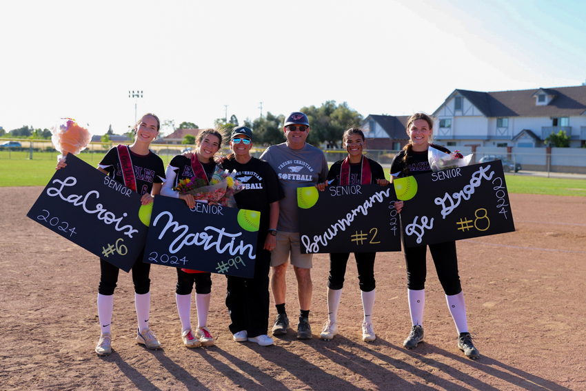 Coach Green takes a photo with her senior players, May 7. 