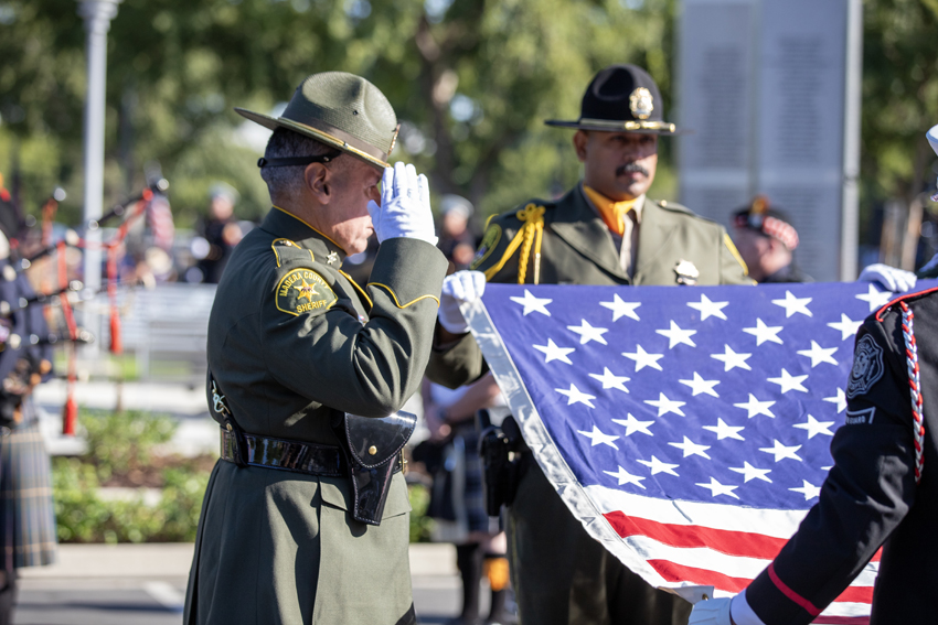 The flag is saluted, our country's bravery honored.