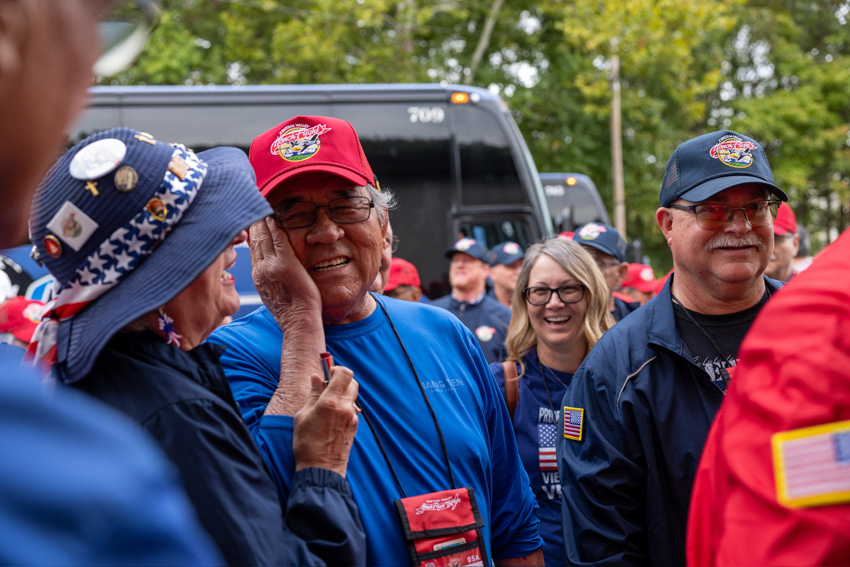 Johns Shiba receiving the traditional red lip kiss on the cheek from CV honor flight volunteers on their way into dinner. 