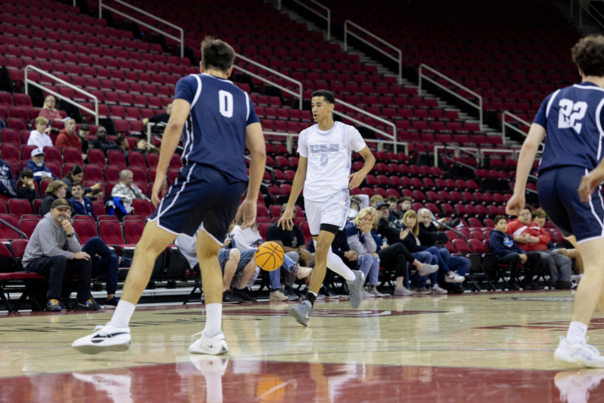 Devin Gaines '26, dribbles past half court to start the offense.