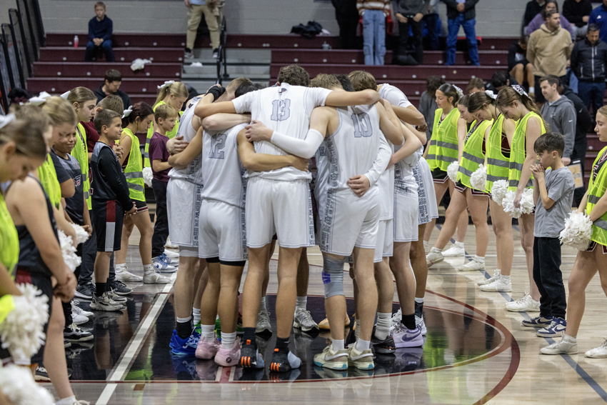 Boys Basketball huddles for a pre-game prayer