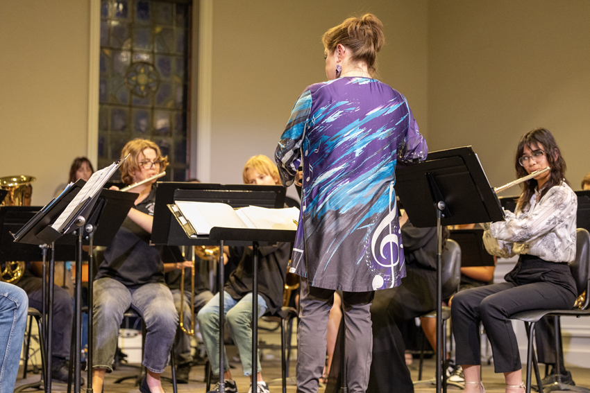 Band director, Linsey Clarno, conducts FC Band during the 2025 Spring Concert. 