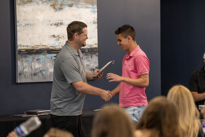 Nathan Bridges receiving an award directly from Jon Penberthy.