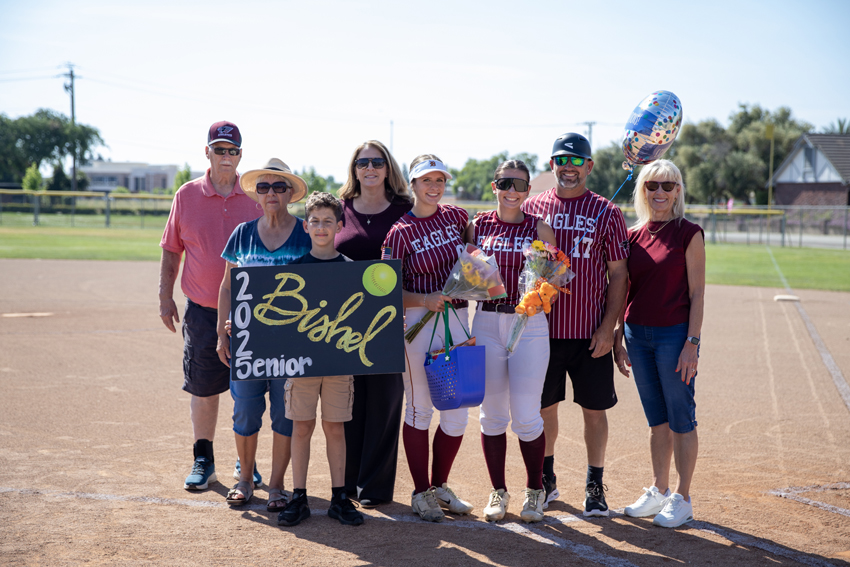 Senior Ava Bishel celebrates four years of softball accompanied by her sister and dad as coach for her final season.