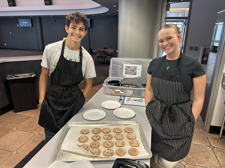 Seniors Asher D'Acquisto and Tayla Tarlton finish baking cinnamon sugar churro cookies.