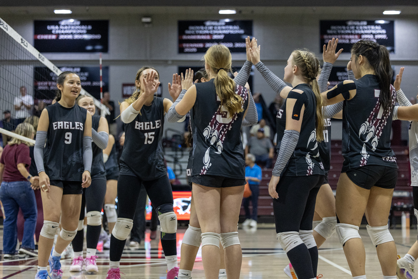 FC girls volleyball celebrates amongst themselves after their win.