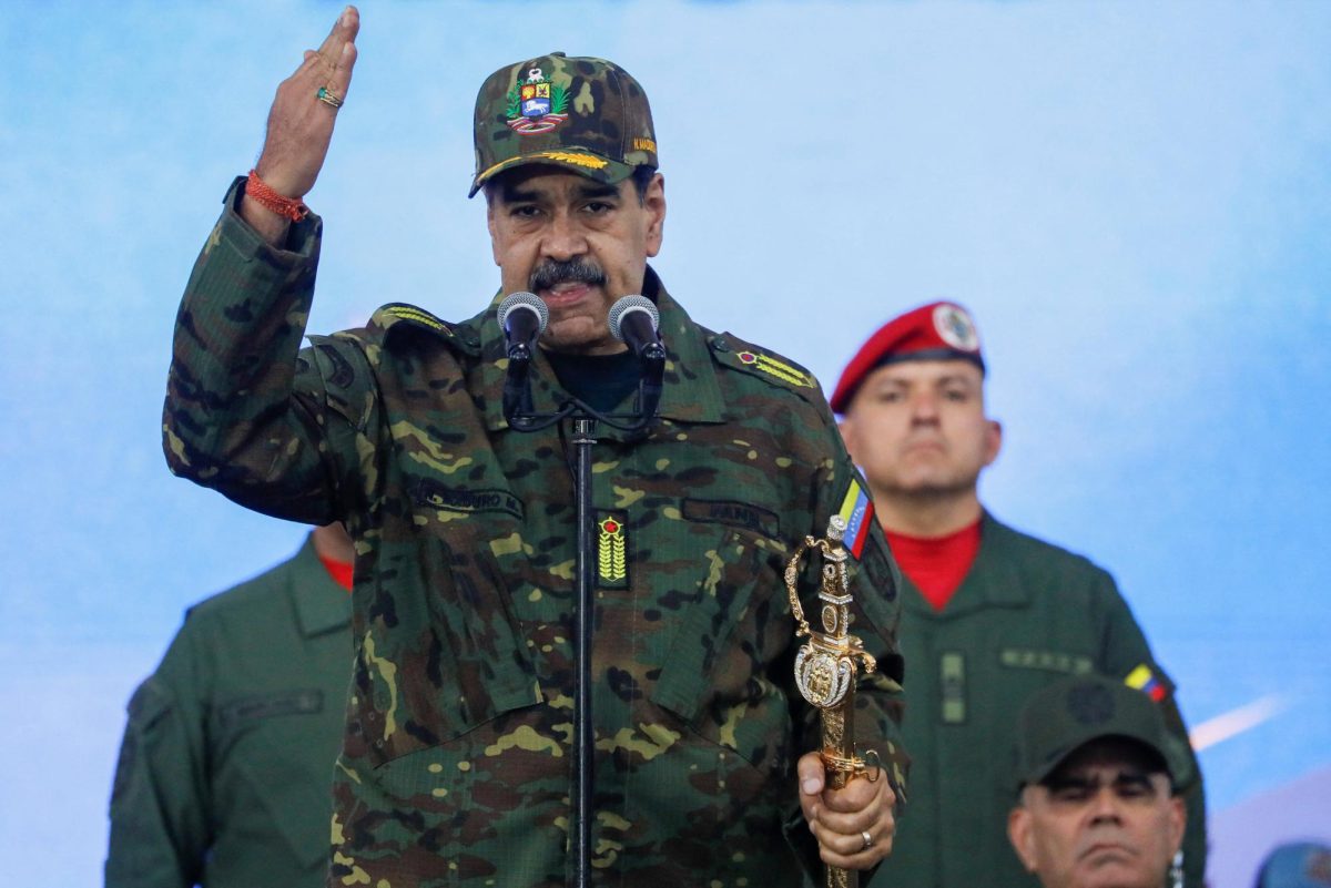 Venezuela's President Nicolas Maduro holds Simon Bolivar's sword as he addresses members of the armed forces, Bolivarian Militia, police, and civilians during a rally against a possible escalation of U.S. actions toward the country, at Fort Tiuna military base in Caracas, Venezuela, November 25, 2025. REUTERS/Leonardo Fernandez Viloria