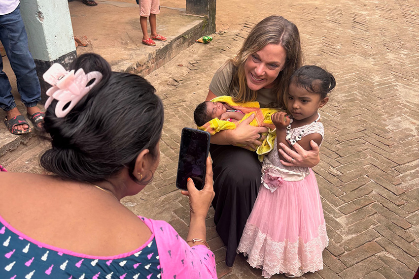 Principal Amy Deffenbacher had the opportunity to show love to many of the people they visited but especially loved holding babies.