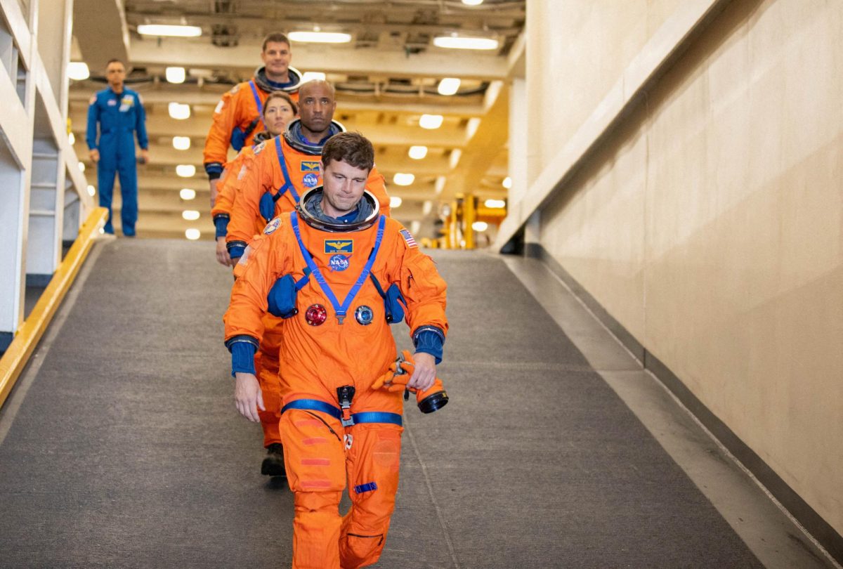 NASA's Artemis II crew members Canadian Space Agency (CSA) astronaut Jeremy Hansen and NASA astronauts Christina Koch, Victor Glover and Reid Wiseman descend the well deck of the USS San Diego as NASA's Exploration Ground System's Landing and Recovery team and partners from the Department of Defense aboard the ship practice recovery procedures using the Crew Module Test Article, during Underway Recovery Test 11 (URT-11) off the coast of San Diego, California February 25, 2024. Isaac Watson/NASA/Handout via REUTERS