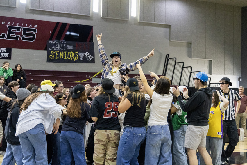 Seniors gather together for a special cheer by lifting fellow classmate Garrett Reed.