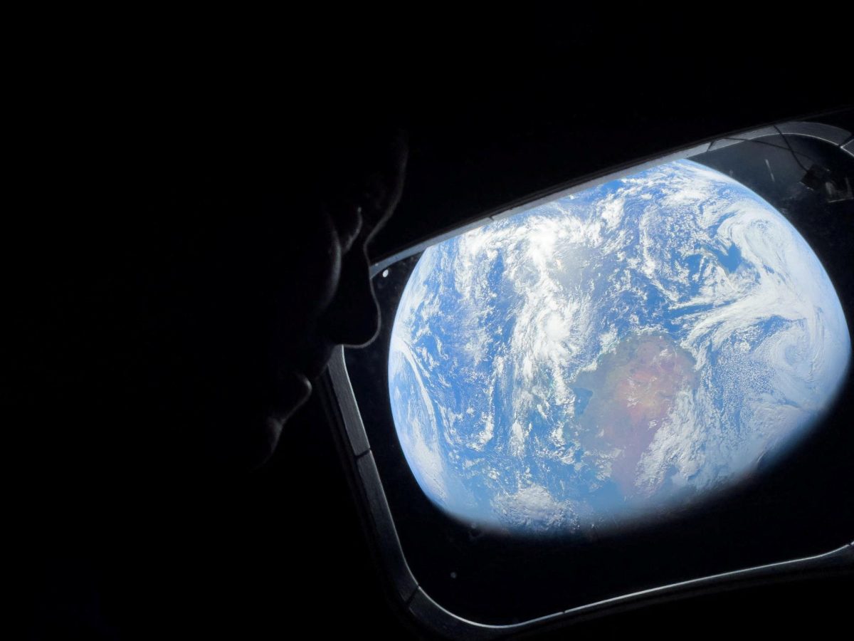 NASA astronaut and Artemis II Commander Reid Wiseman peers out of one of the Orion spacecraft's main cabin windows, looking back at Earth, as the crew travels towards the Moon April 2, 2024.  NASA/Handout via REUTERS. THIS IMAGE HAS BEEN SUPPLIED BY A THIRD PARTY.