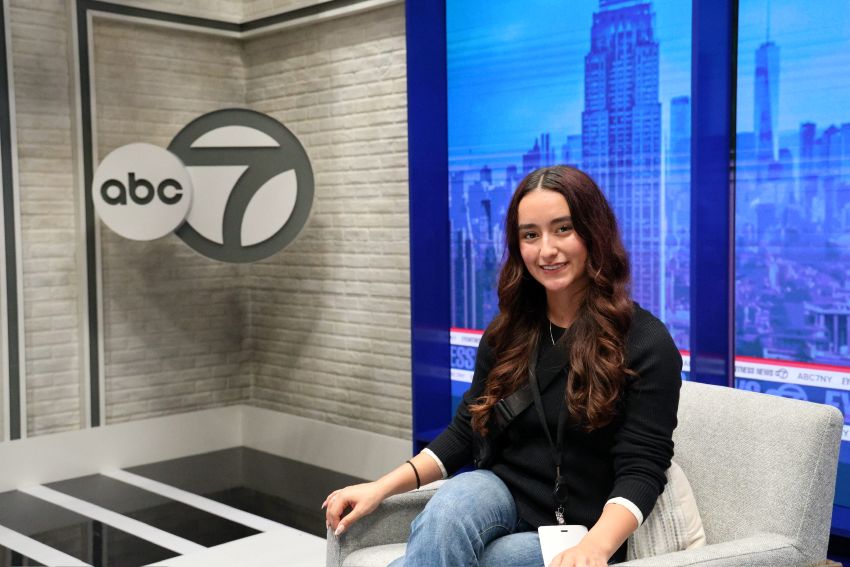 Kyleigh Baca,'26, sits in the same seat as professional newscasters while visiting ABC studios in New York City.